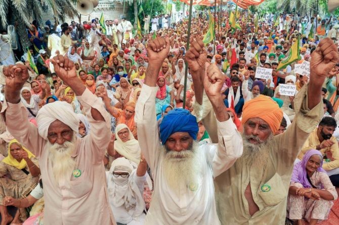 Farmers raise slogans during an ongoing protest outside the residence of former chief minister Parkash Singh Badal against three agriculture-related bills, at Badal village in Sri Muktsar Sahib, on Friday. Photograph: PTI Photo